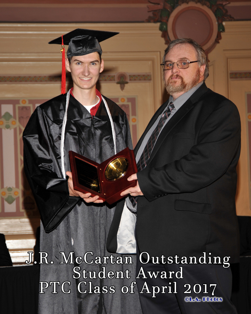 A student being presented an award by an instructor. J.R. McCartan Outstanding Student Award PTC Class of April 2017