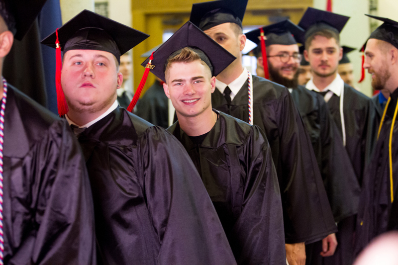 Students walking down the aisle at graduation 