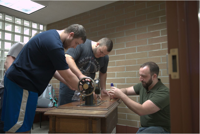 CAD students restoring a 1901 Singer sewing machine 