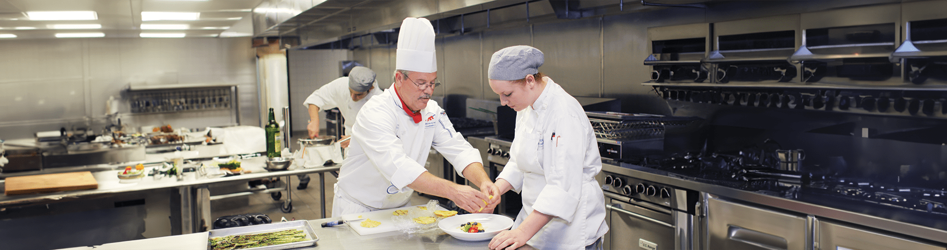 Chef Hutchins working with a culinary student.