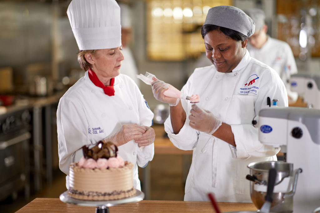 Culinary Arts student icing a cake