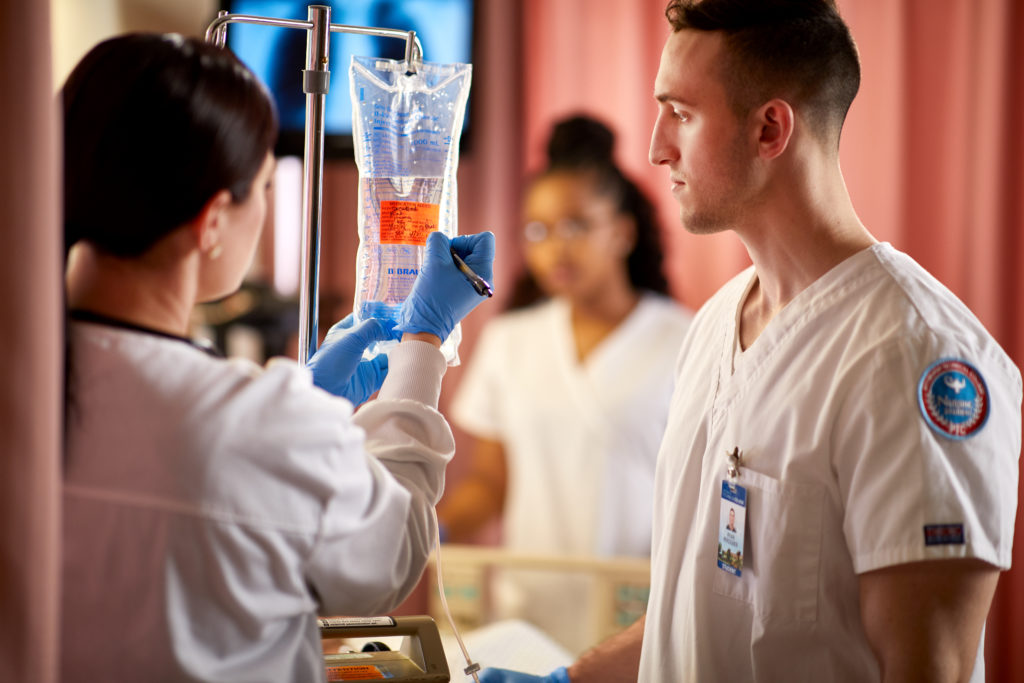 Nursing students setting up an IV