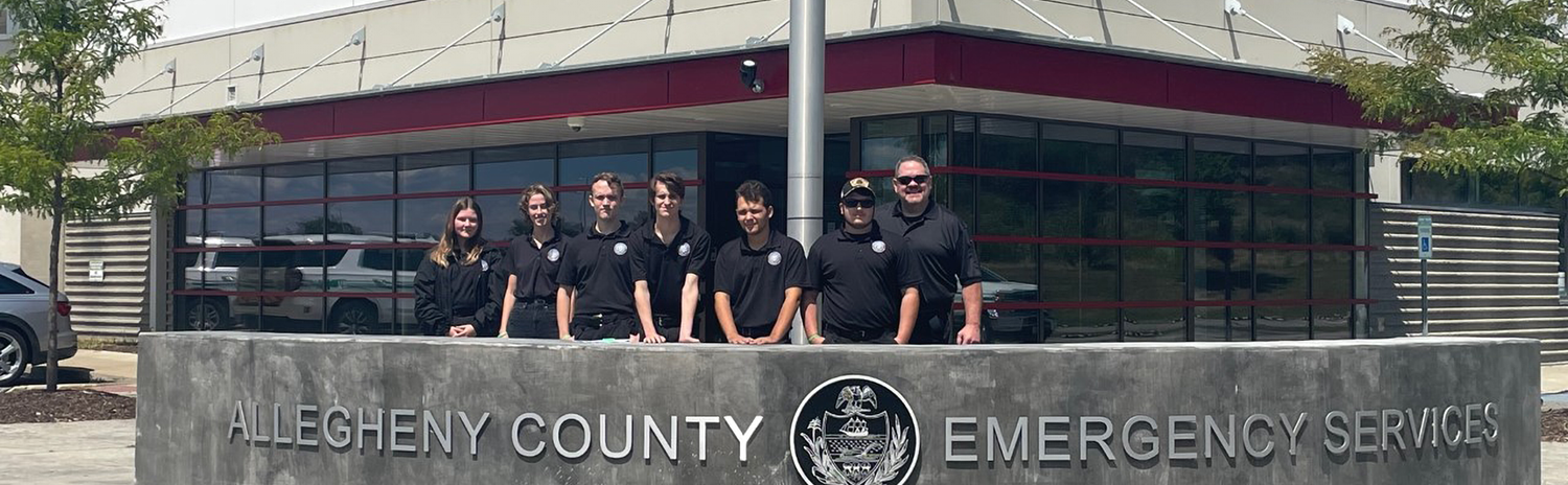 A group photo of the Criminal Justice class standing in front of the Allegheny County Emergency Services building.