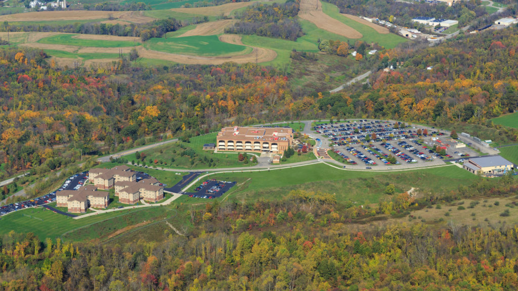 aerial view of the campus, parking, and housing
