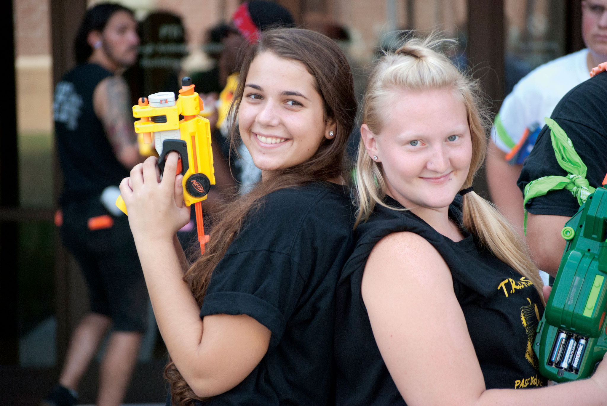 students standing back to back with Nerf guns