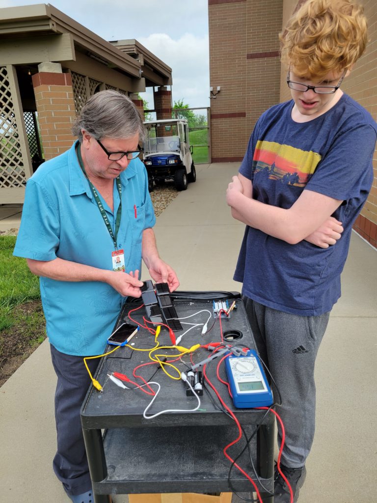 Dr McNeill and Zach C testing solar charge