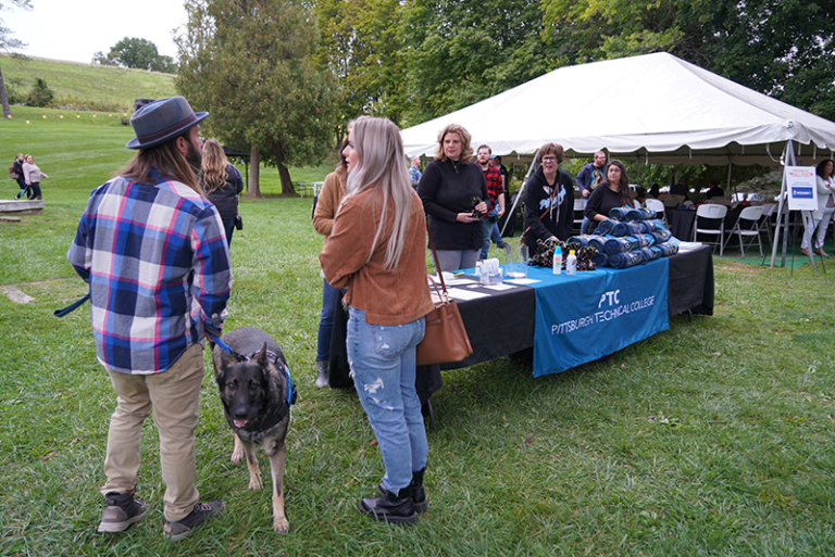 A photo of an alum with their dog at the Alumni Fall Fest.