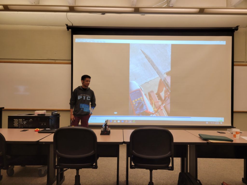 Student showing a project for sstem.