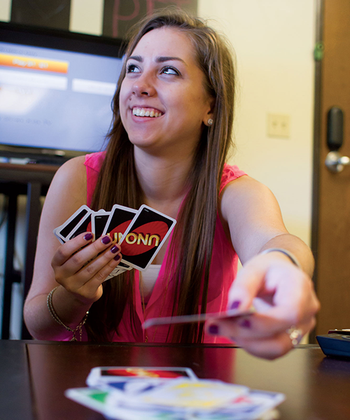 student playing UNO card game