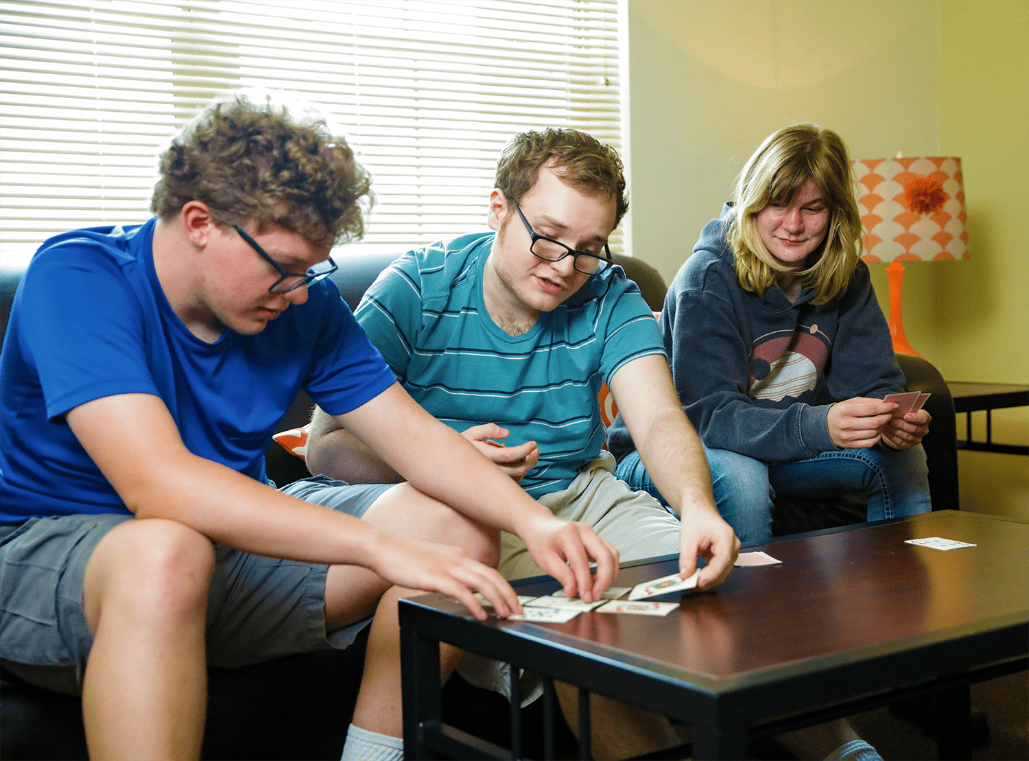 A photo of students playing cards in their dorm.