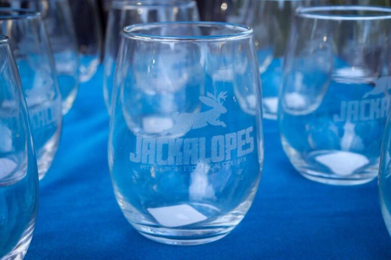 A table lined with Jackalope glasses at the Alumni Fall Fest.