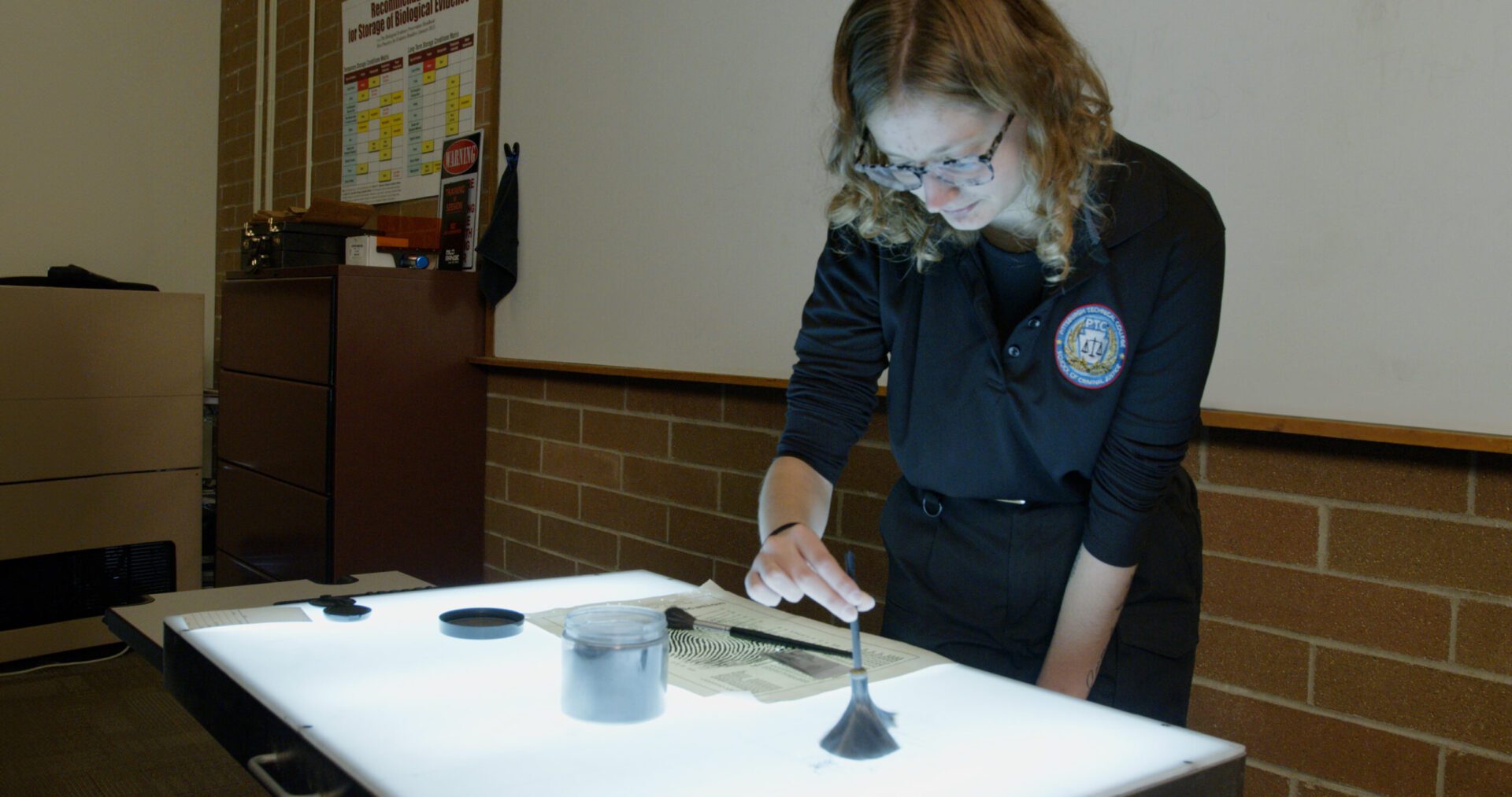 A photo of a Criminal Justice student investigating fingerprints.