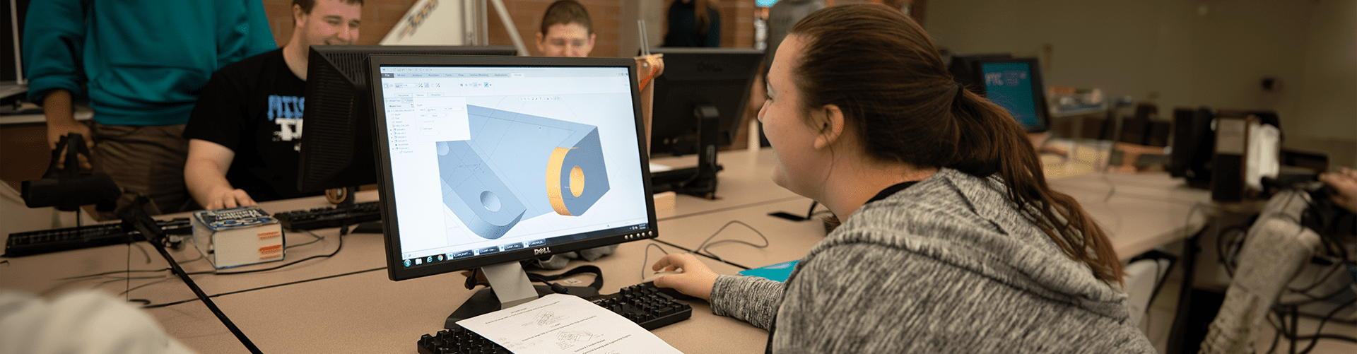 A photo of a student working on her CAD assignment in class.